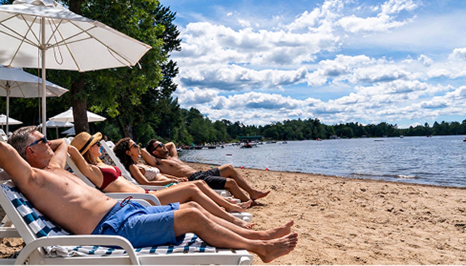 family at the beach lying on beach chairs.